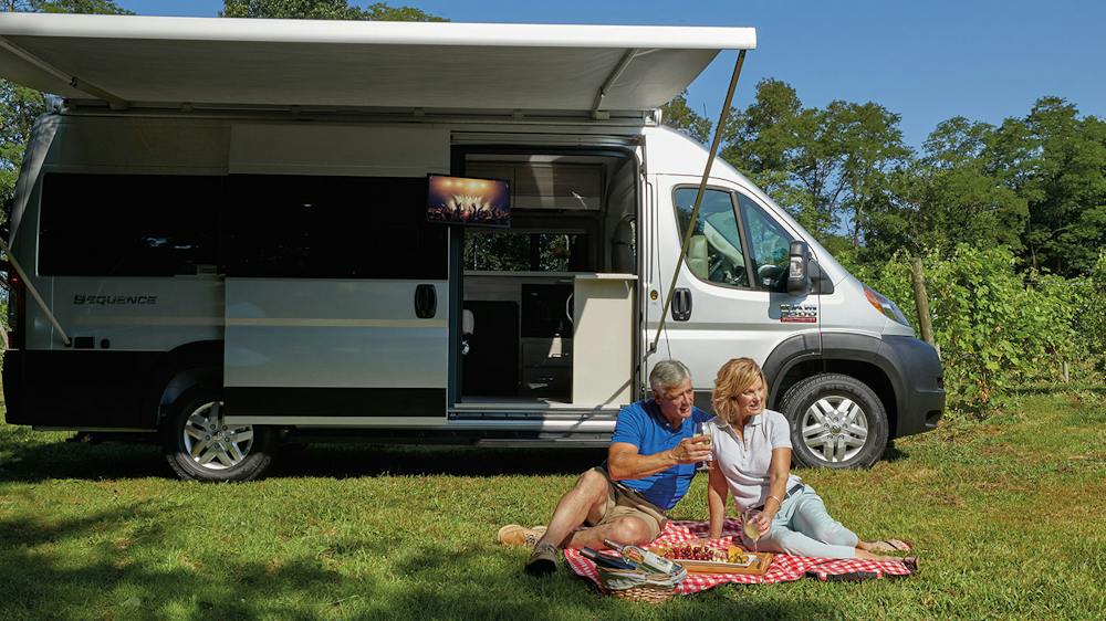 2020 Thor Sequence Class B Camper Van RV lifestyle winery photo shoot couple sitting on picnic blanket at winery slider size 2000 x 800px