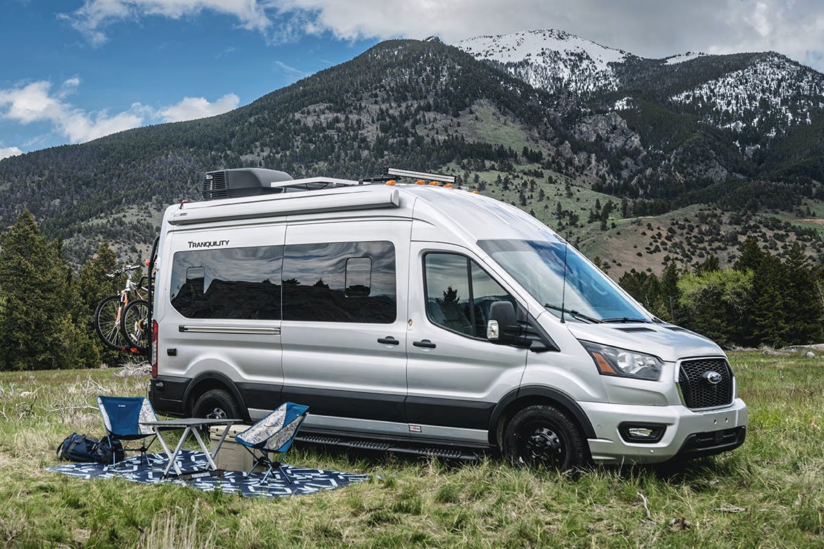 Tranquility Class B Camper Van with outdoor setup in front of big mountain