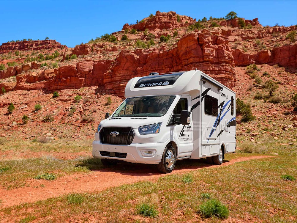 Gemini AWD HD Max Crystal Blue exterior in Utah with rock wall behind