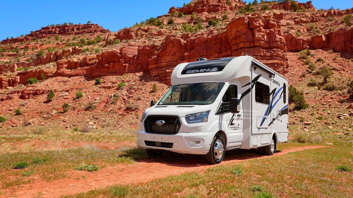 Gemini AWD HD Max Crystal Blue exterior in Utah with rock wall behind