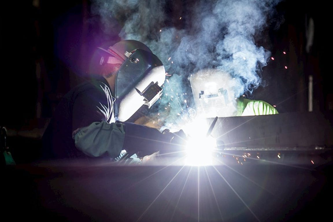 A factory worker welding