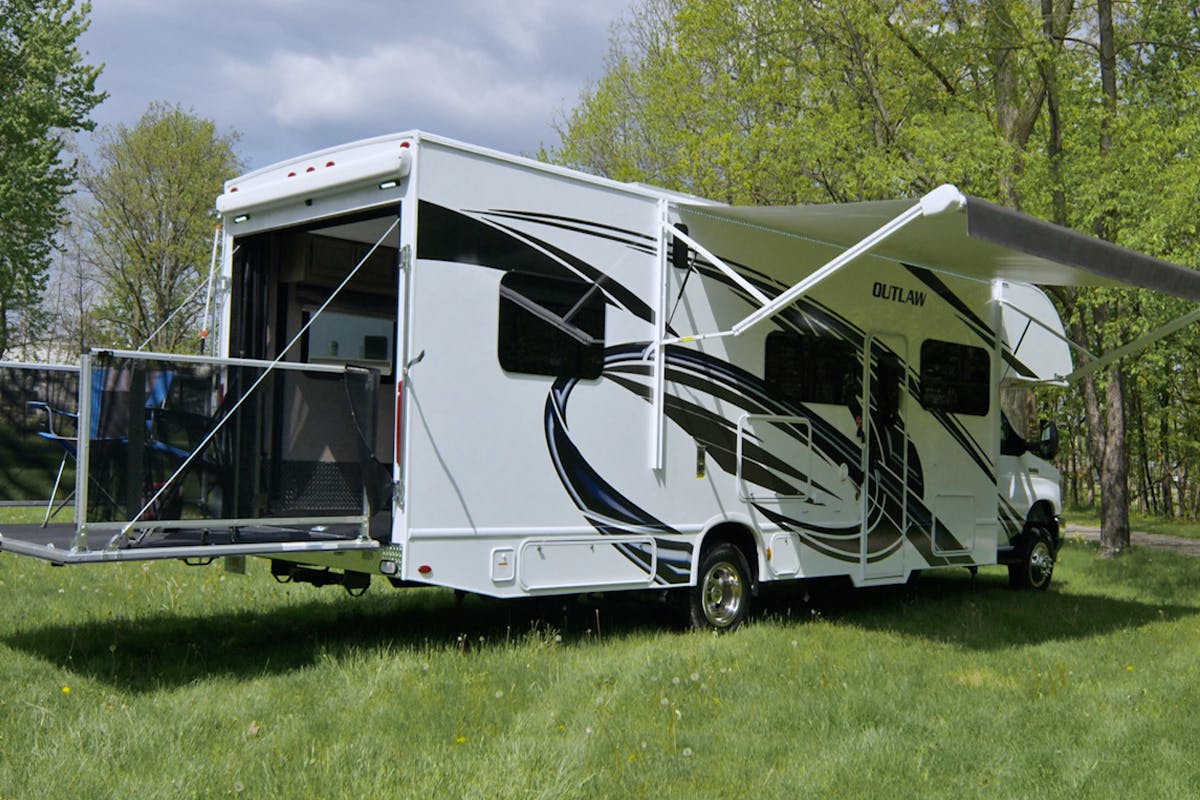 Toy hauler site with awning out and beautiful weather outside