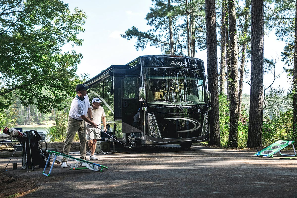 Thor Aria Class A Diesel Pusher RV Motorhome and friends enjoying a campsite